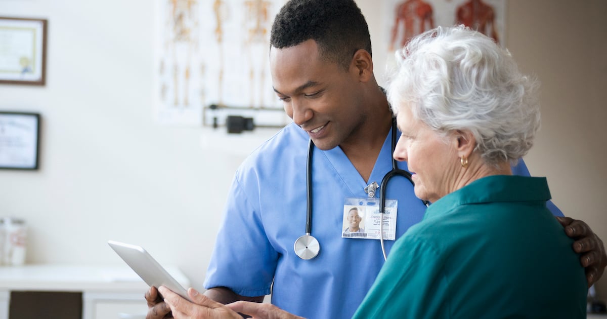 African American doctor with older woman patient